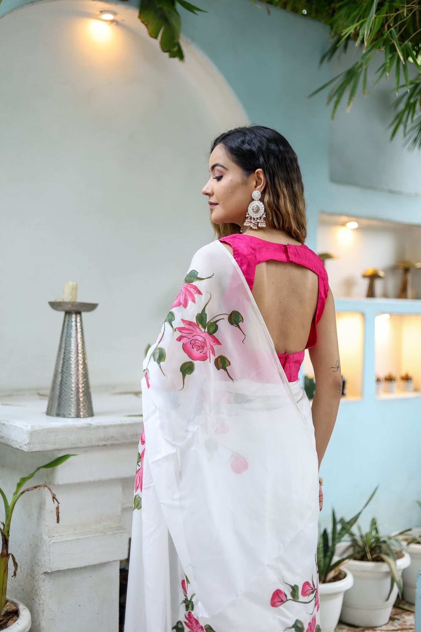 Elegant white floral saree for women featuring pink floral designs and a stylish back neck design