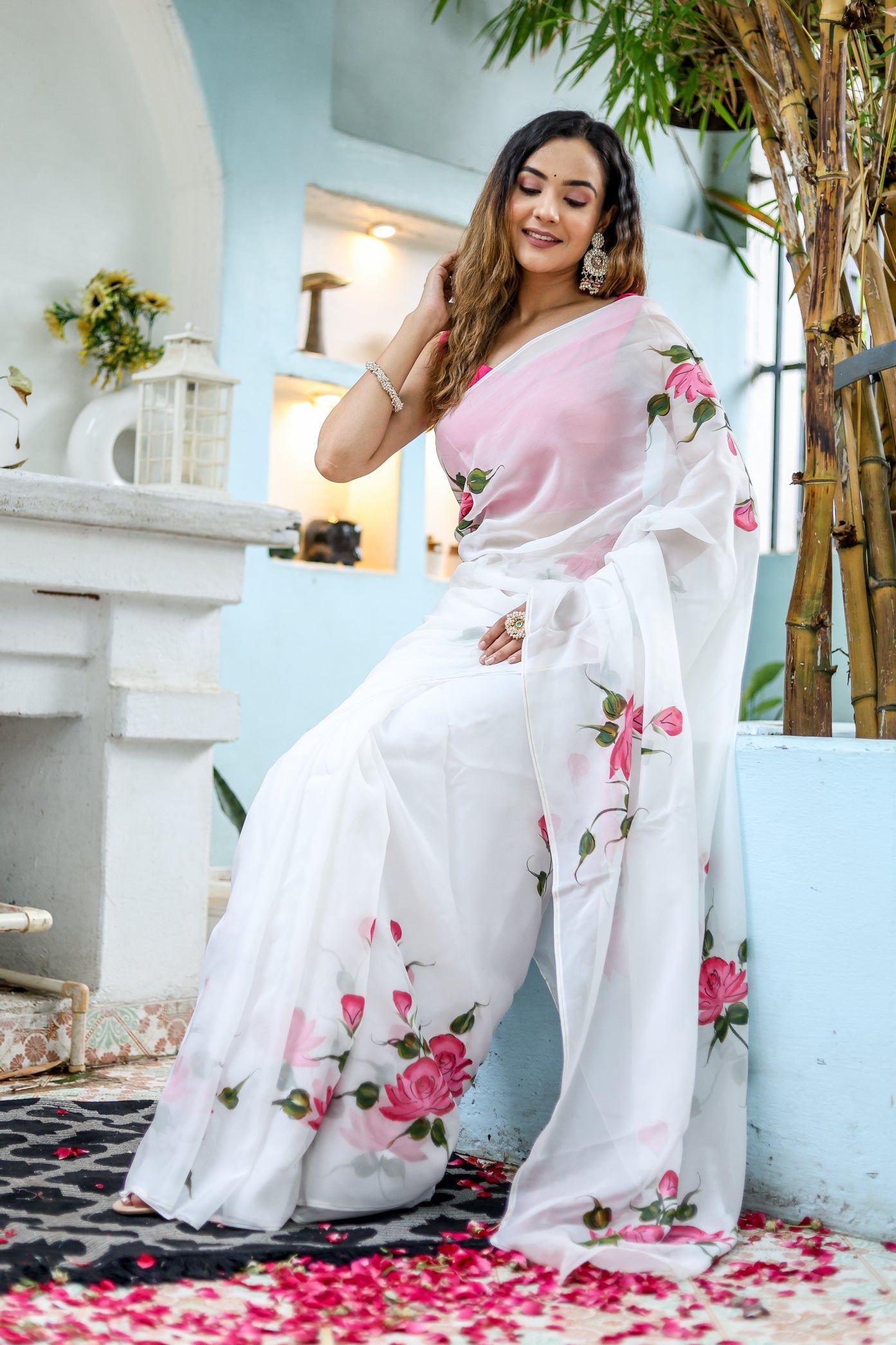 Elegant white floral saree for women featuring pink roses, perfect for festive occasions.