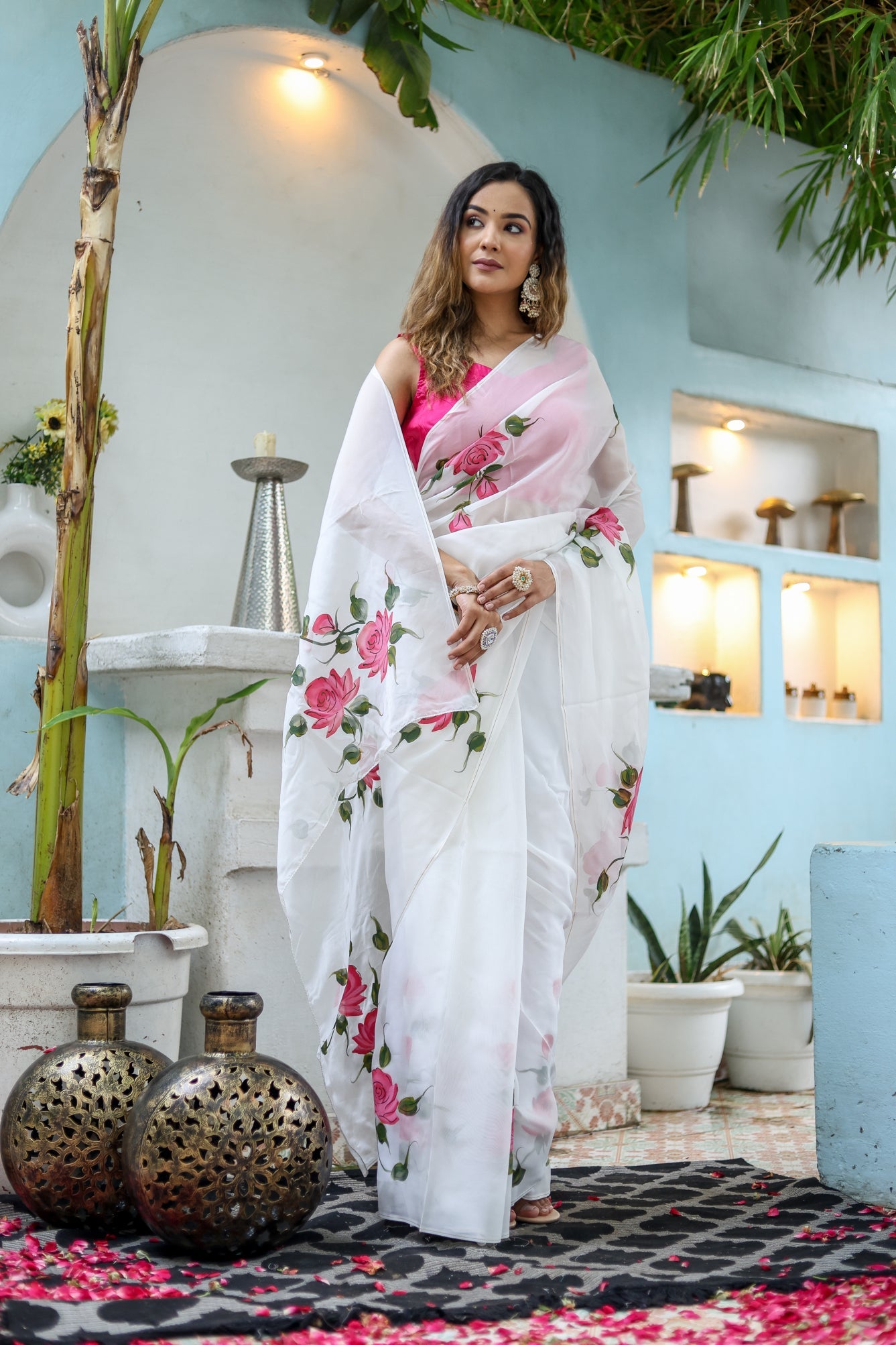 Elegant white floral saree for women featuring pink roses, perfect for special occasions and festive events