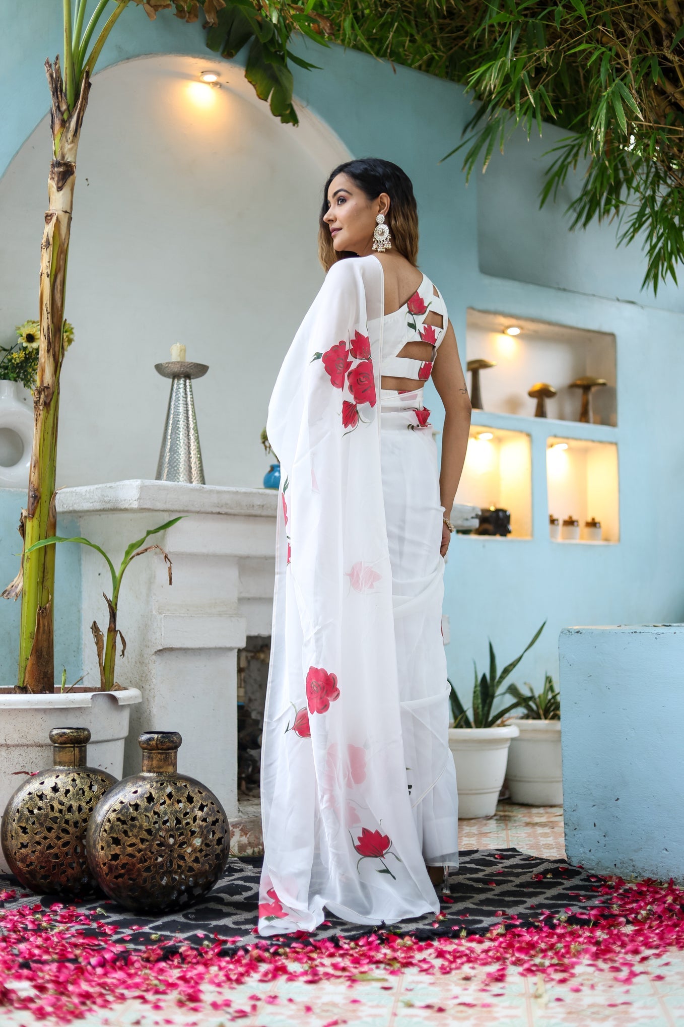 Elegant white organza saree for women featuring floral motifs, perfect for festive occasions.