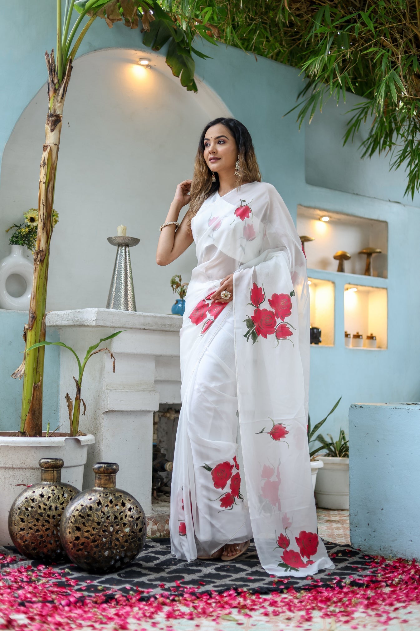Elegant white organza saree for women with red floral prints, perfect for festive occasions.