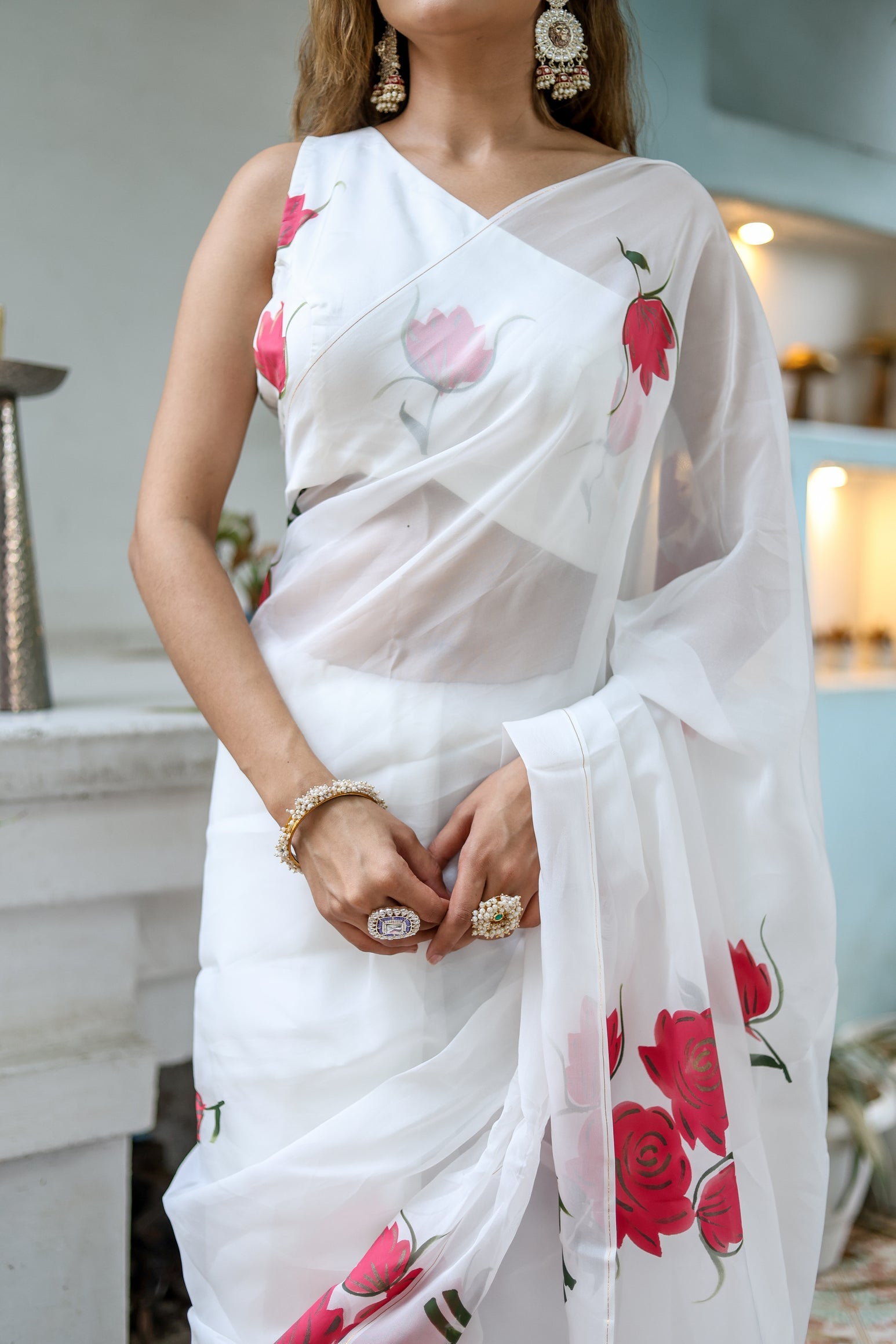 Elegant white organza saree for women with colorful floral prints, perfect for festive occasions