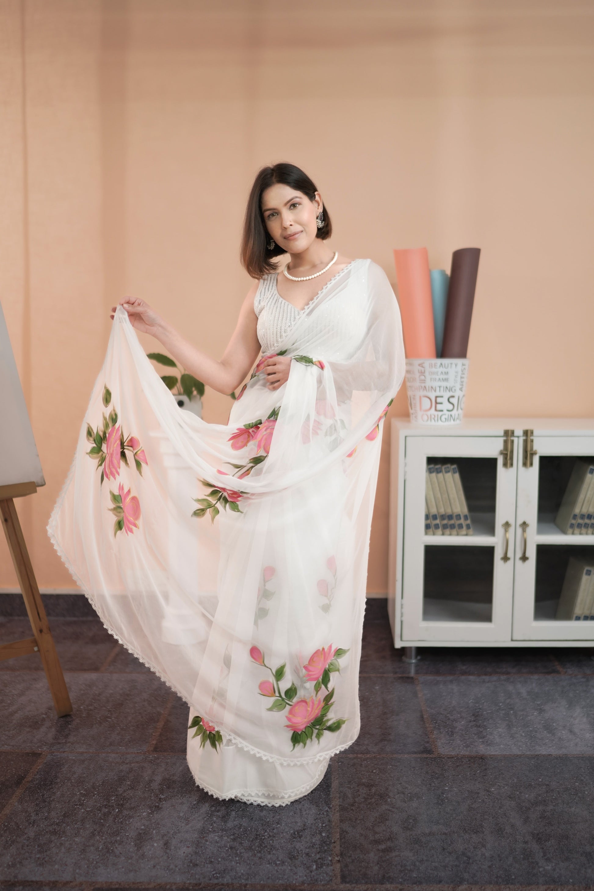 Elegant white saree with pink floral print styled by Stylera for a chic look
