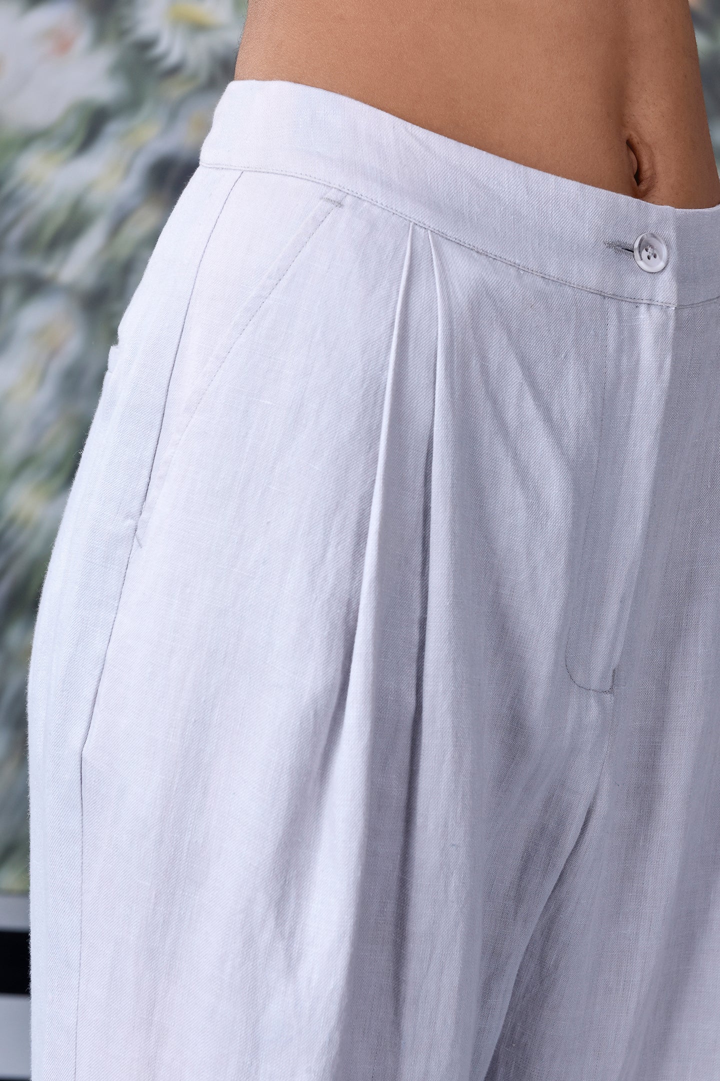 Close-up of women's regular fit linen pants in white by Stylera showcasing button and pocket details