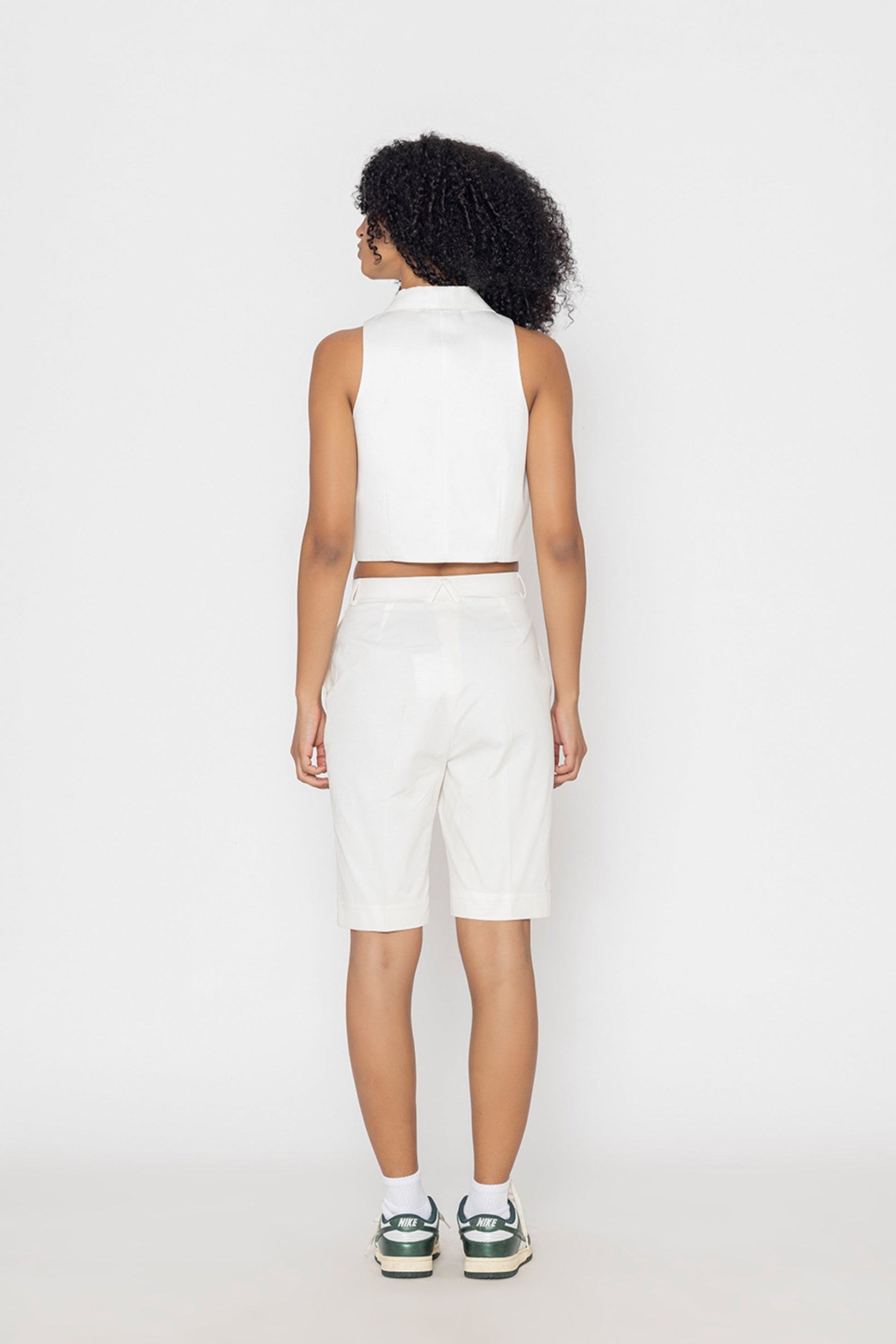 Stylera women's white vest top shown from the back with high neckline and sleeveless design