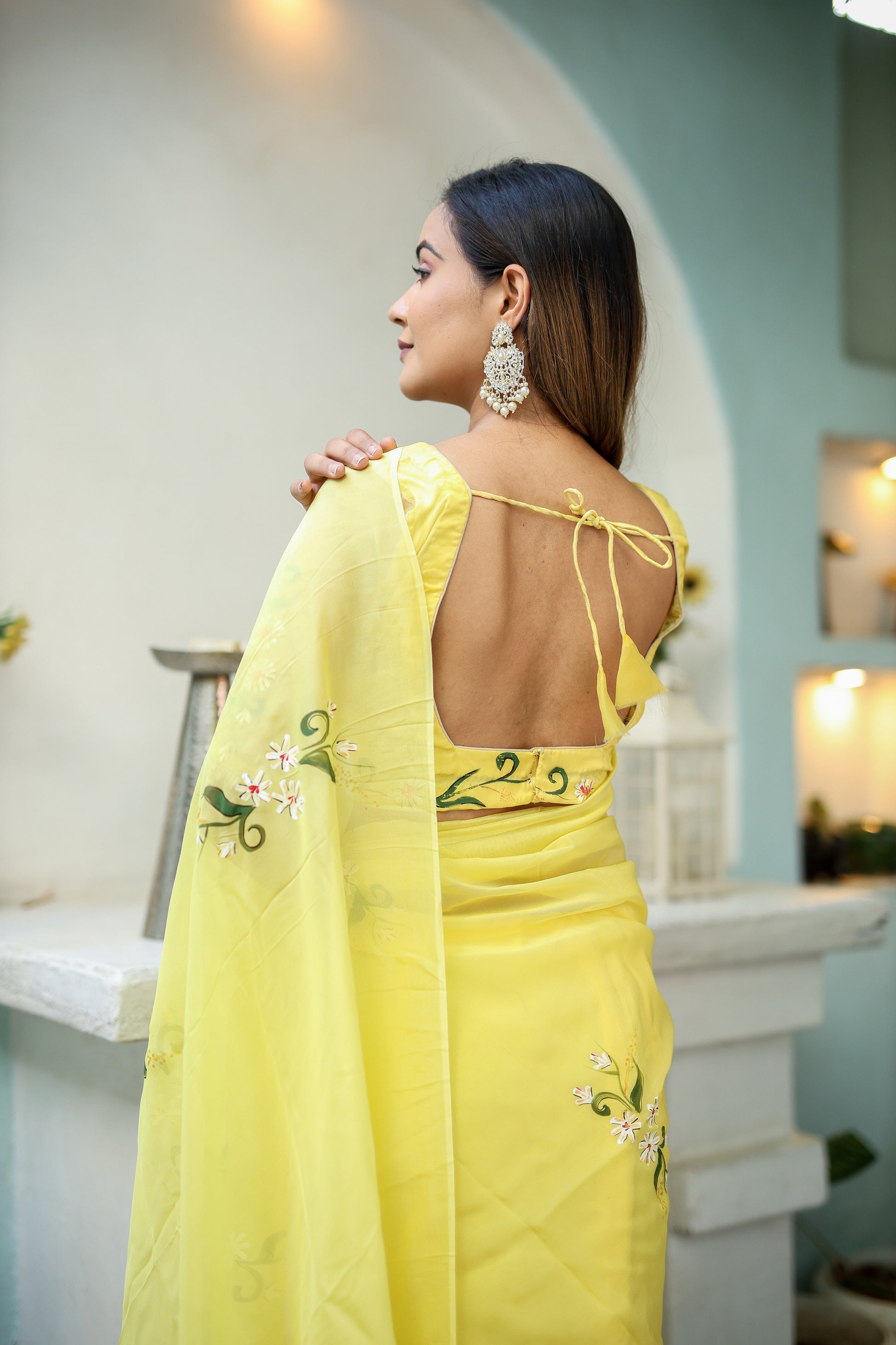 Elegant yellow floral organza saree with a stylish back design and intricate embroidery details