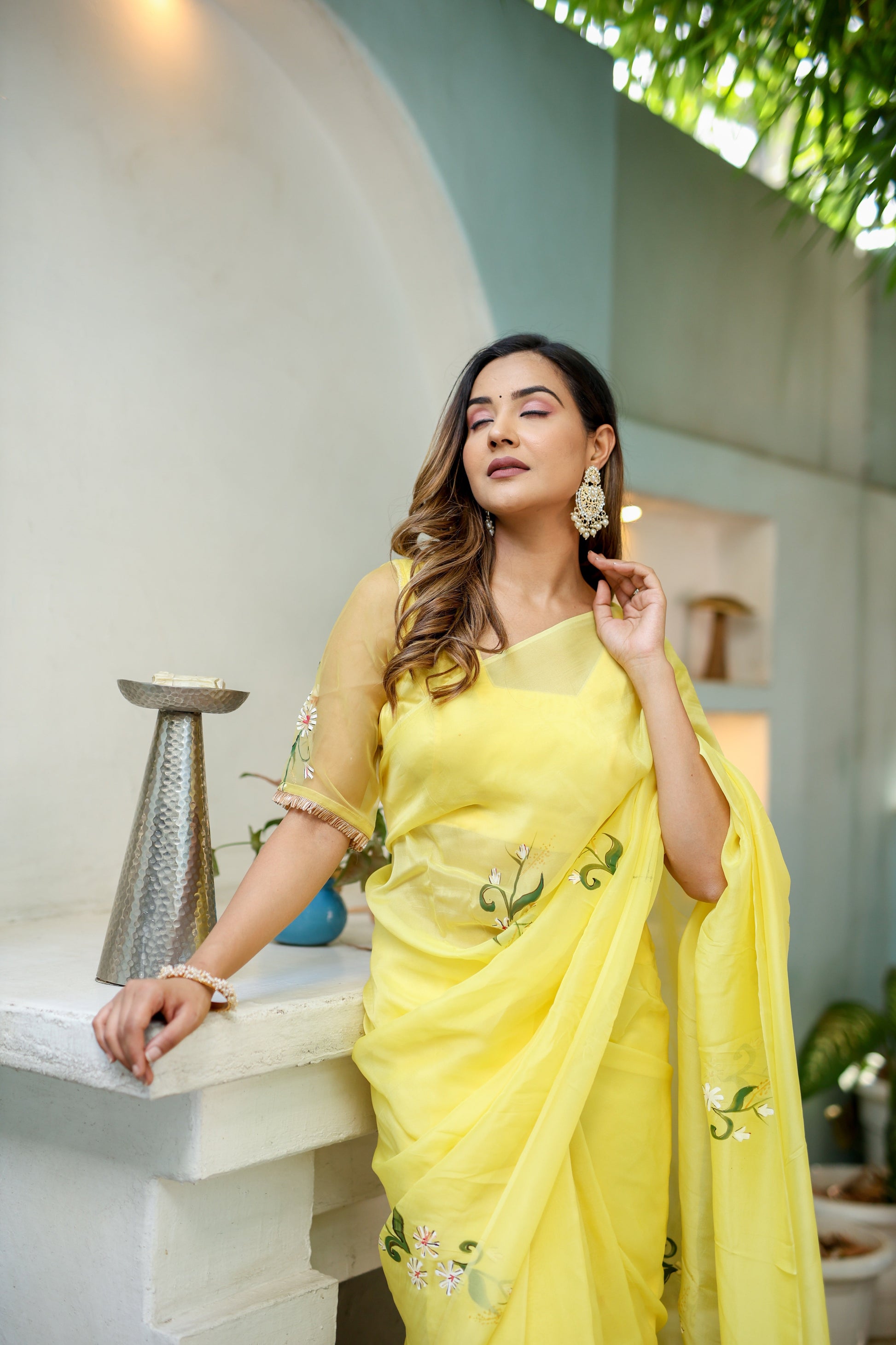 Elegant yellow floral organza saree from Stylera, styled with intricate floral embroidery and a light texture