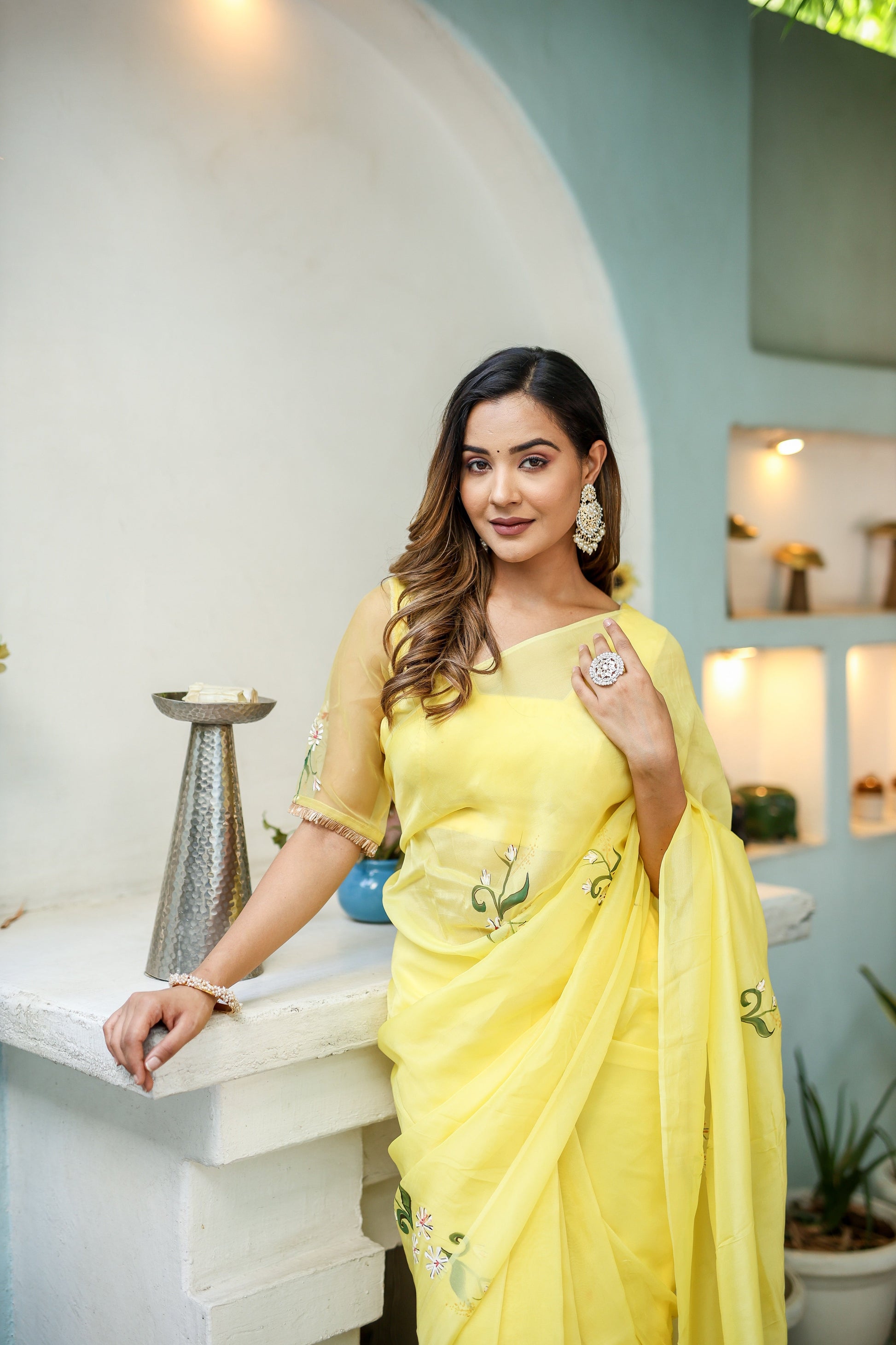 Elegant yellow floral organza saree draped elegantly with intricate embroidery for a stylish look