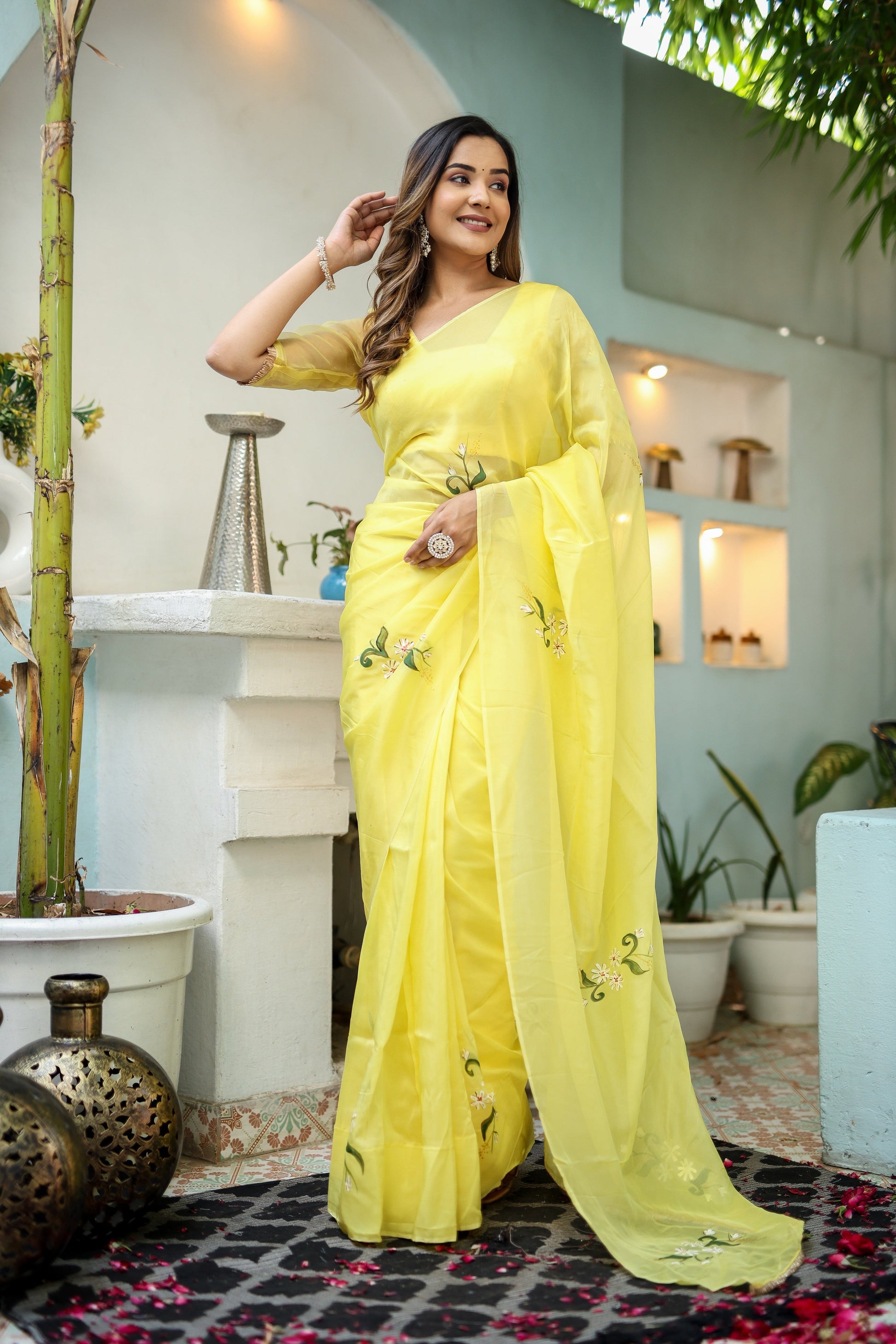 Elegant yellow floral organza saree from Stylera with delicate embroidery for festive occasions.
