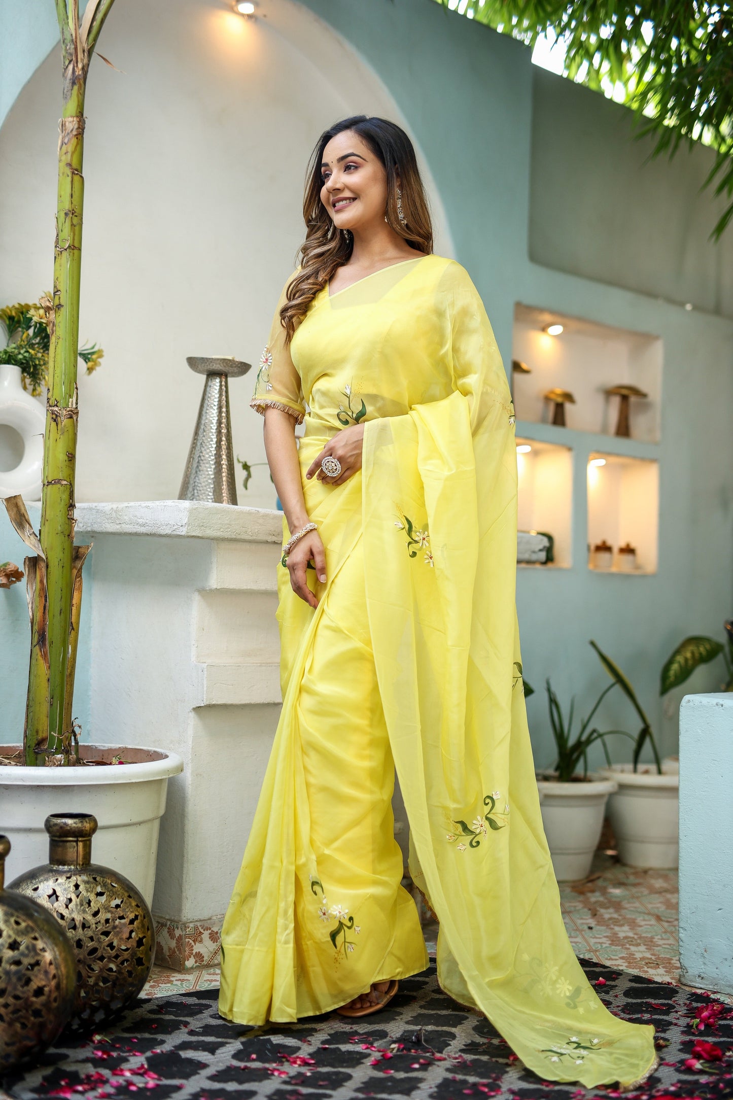 Elegant yellow floral organza saree with delicate embroidery, perfect for festive occasions