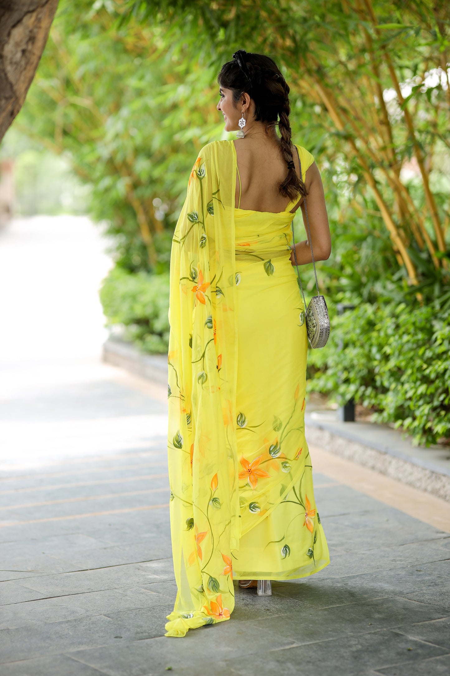 Elegant yellow saree with floral print, showcasing delicate designs and a flowing silhouette