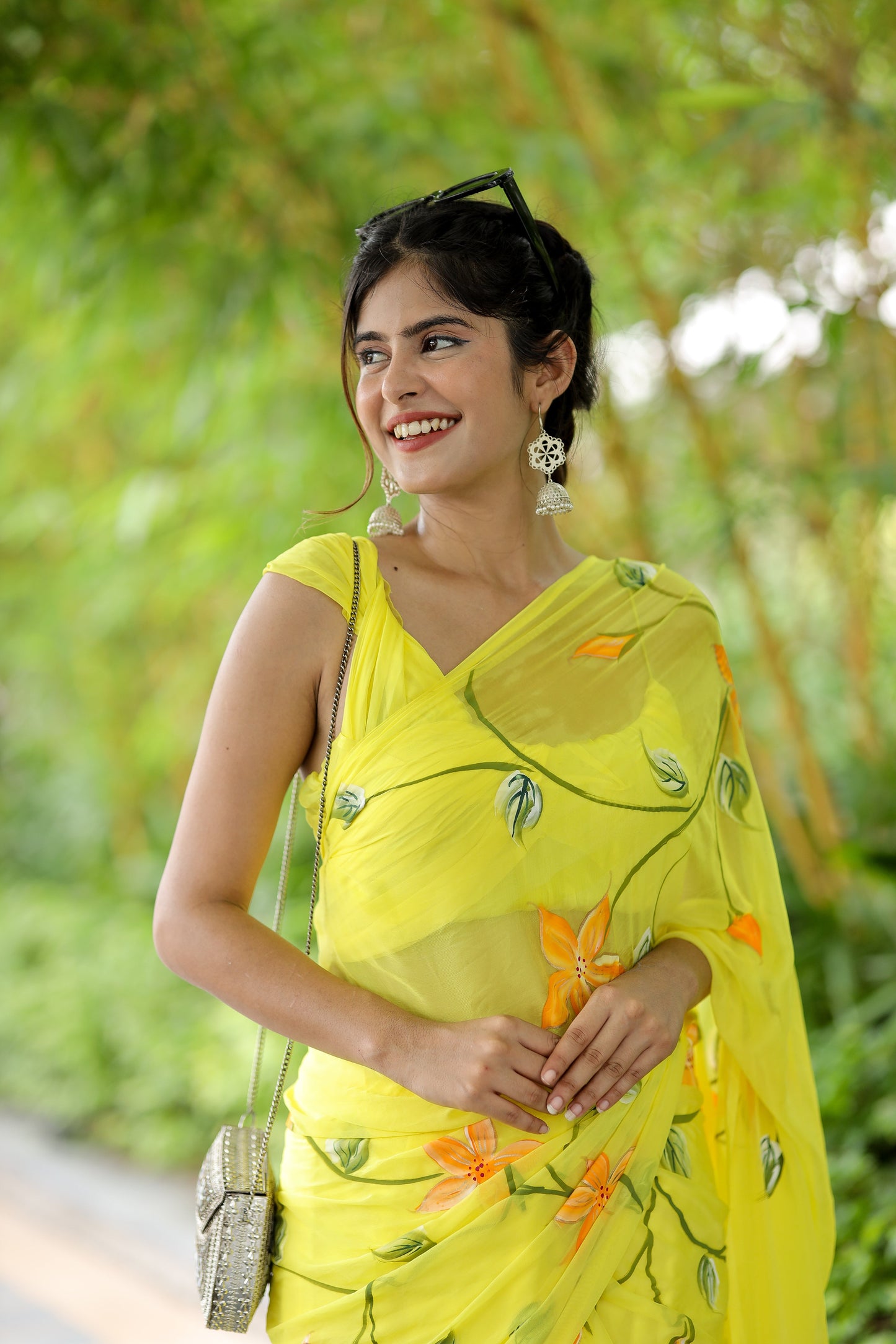 Elegant yellow saree with floral print draped gracefully, perfect for festive occasions