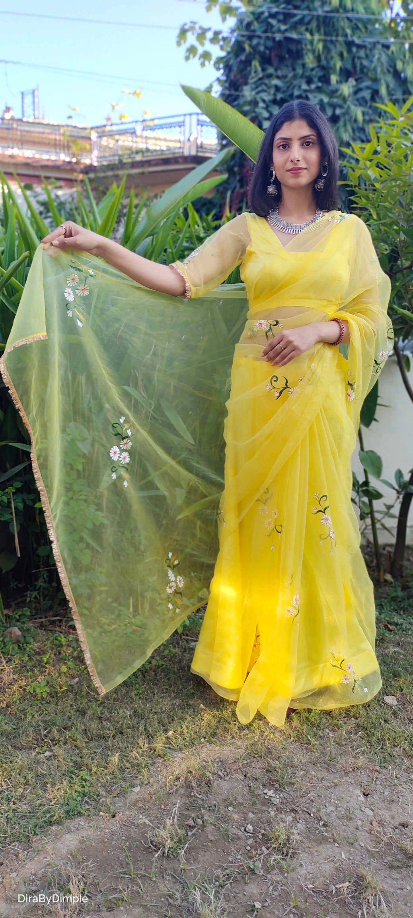 Model wearing a yellow sunflower saree with floral embroidery, showcasing elegance and style.