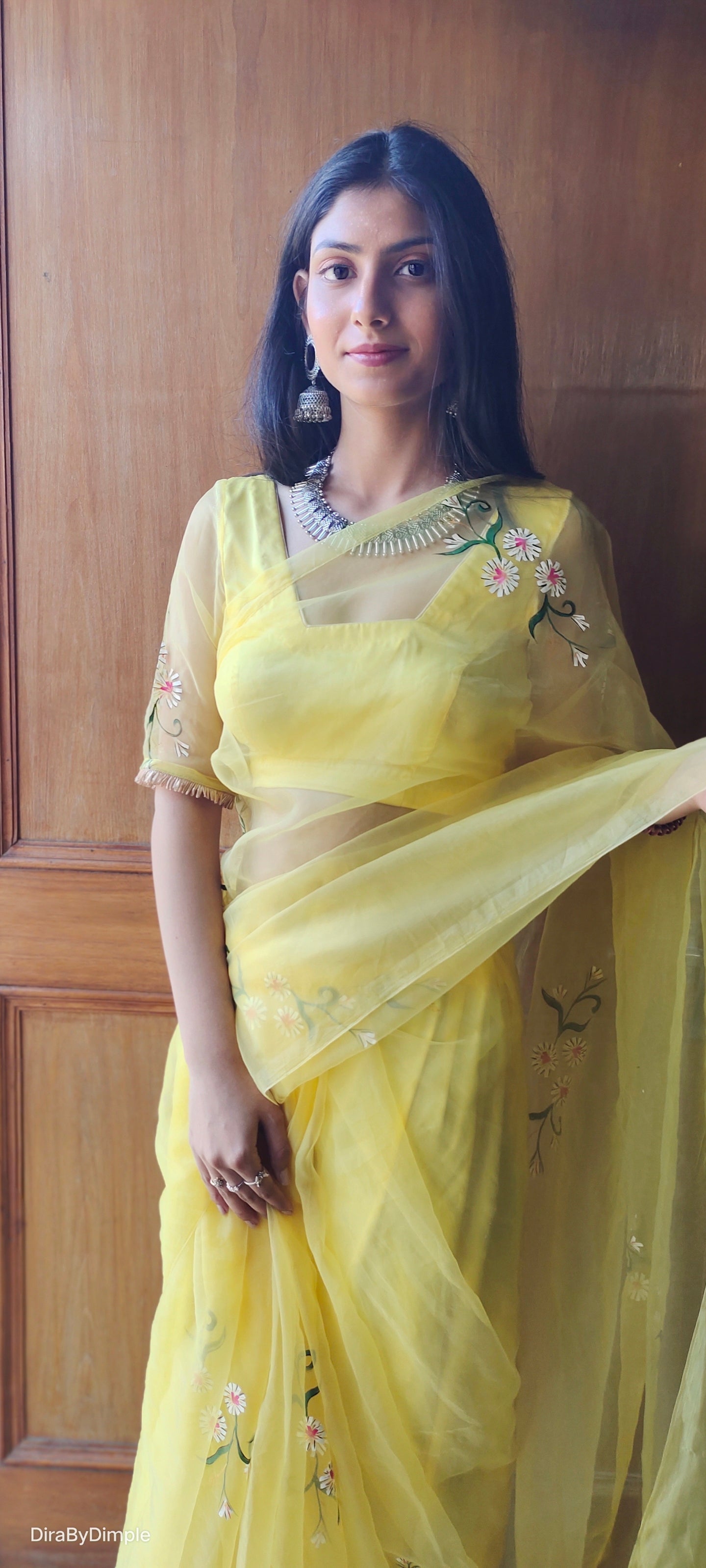 Model wearing a yellow sunflower saree with elegant floral embroidery showcasing a traditional style