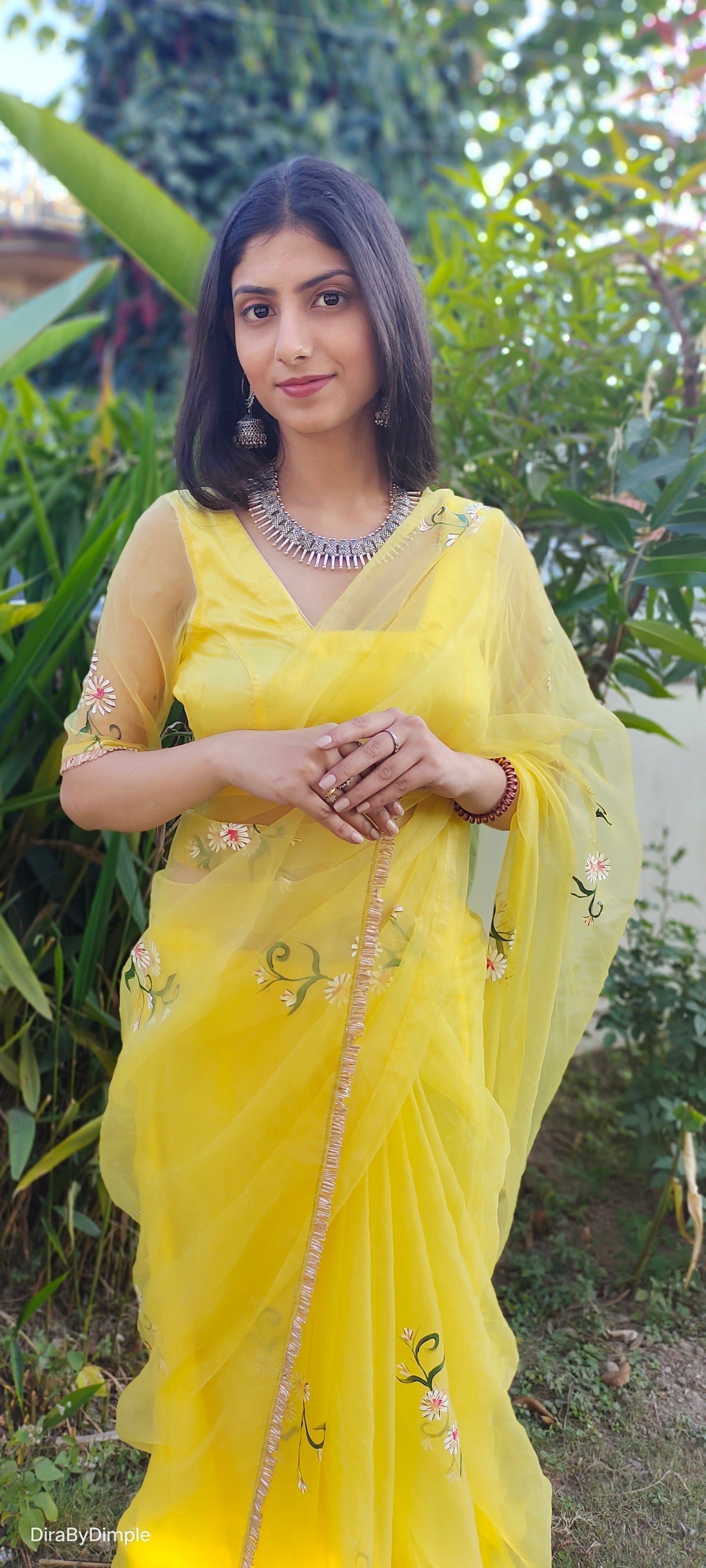 Model wearing a beautiful yellow sunflower saree with floral embroidery and elegant styling