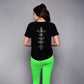 A woman in bright green leggings wears the 'Pilates Has Your Back' Printed Tee, featuring the motivational slogan on the back—perfect for workouts or casual wear.