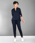 Woman wearing the Accented Set—a navy cotton co-ord featuring a button-up shirt and matching pants—smiling against a plain gray background.