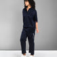 A woman wears the Navy Blue Chic Set—a navy co-ord with a batwing sleeve shirt and matching pants—standing against a plain gray background.
