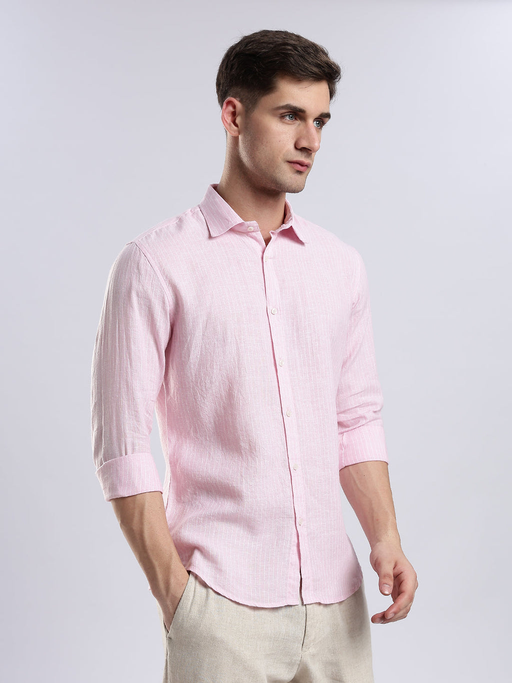 Stylera men’s light pink linen-blend shirt in a slim fit paired with beige trousers.