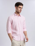 Stylera men’s light pink linen-blend shirt in a slim fit paired with beige trousers.