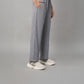 Wearing the Grey Tie Up Top with Loose Pants Cord Set and white sneakers, the person stands against a plain background.