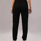 Model wears the Black Co-Ord Set, seen from the back against a plain background—a sleek, coordinated outfit made from comfortable cotton lycra and styled with white sneakers.