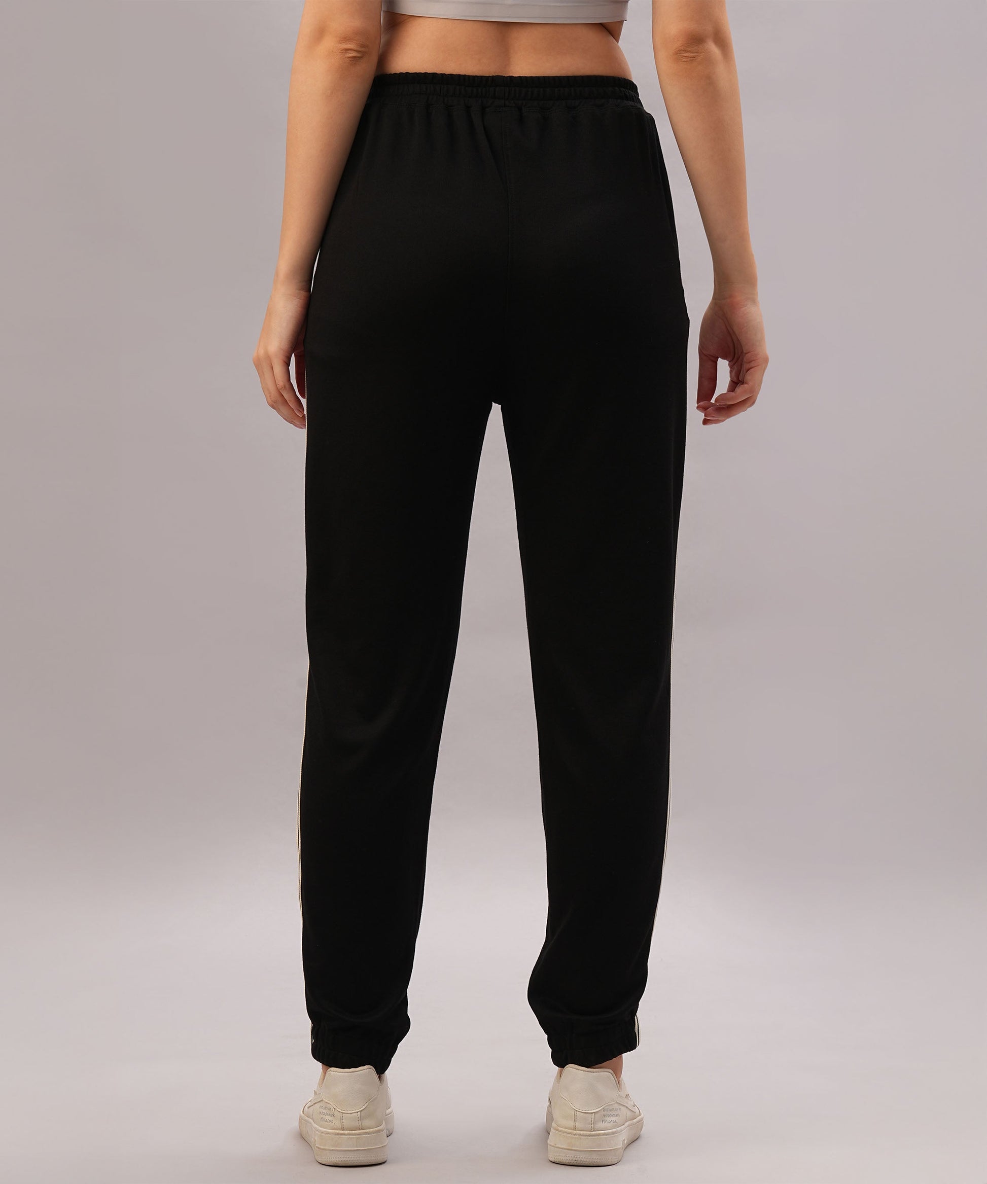 Model wears the Black Co-Ord Set, seen from the back against a plain background—a sleek, coordinated outfit made from comfortable cotton lycra and styled with white sneakers.