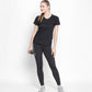 Woman wearing the Tuna London Sara Basic Sports Tee With Net Detailing for Women, holding a water bottle and smiling against a white background.