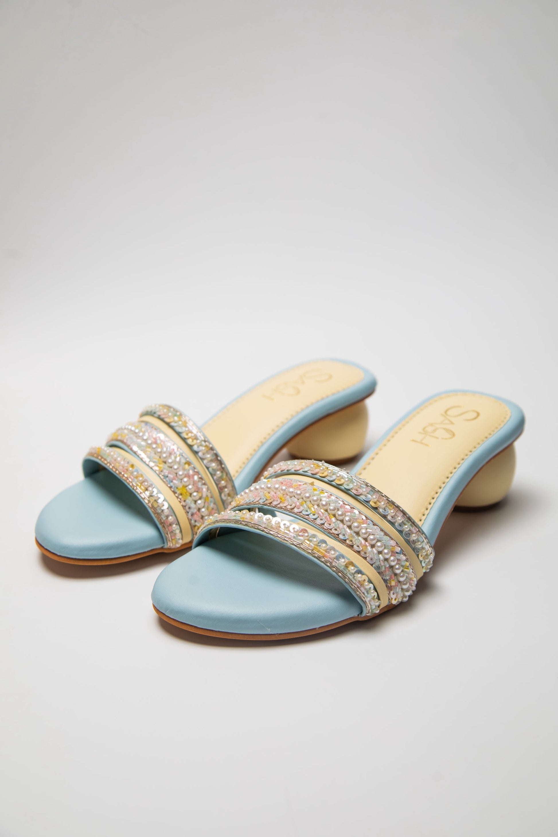 Powder Blue round 2 inch heels with slide straps of intrictae pastel pink, yellow and blue handwork with pearls