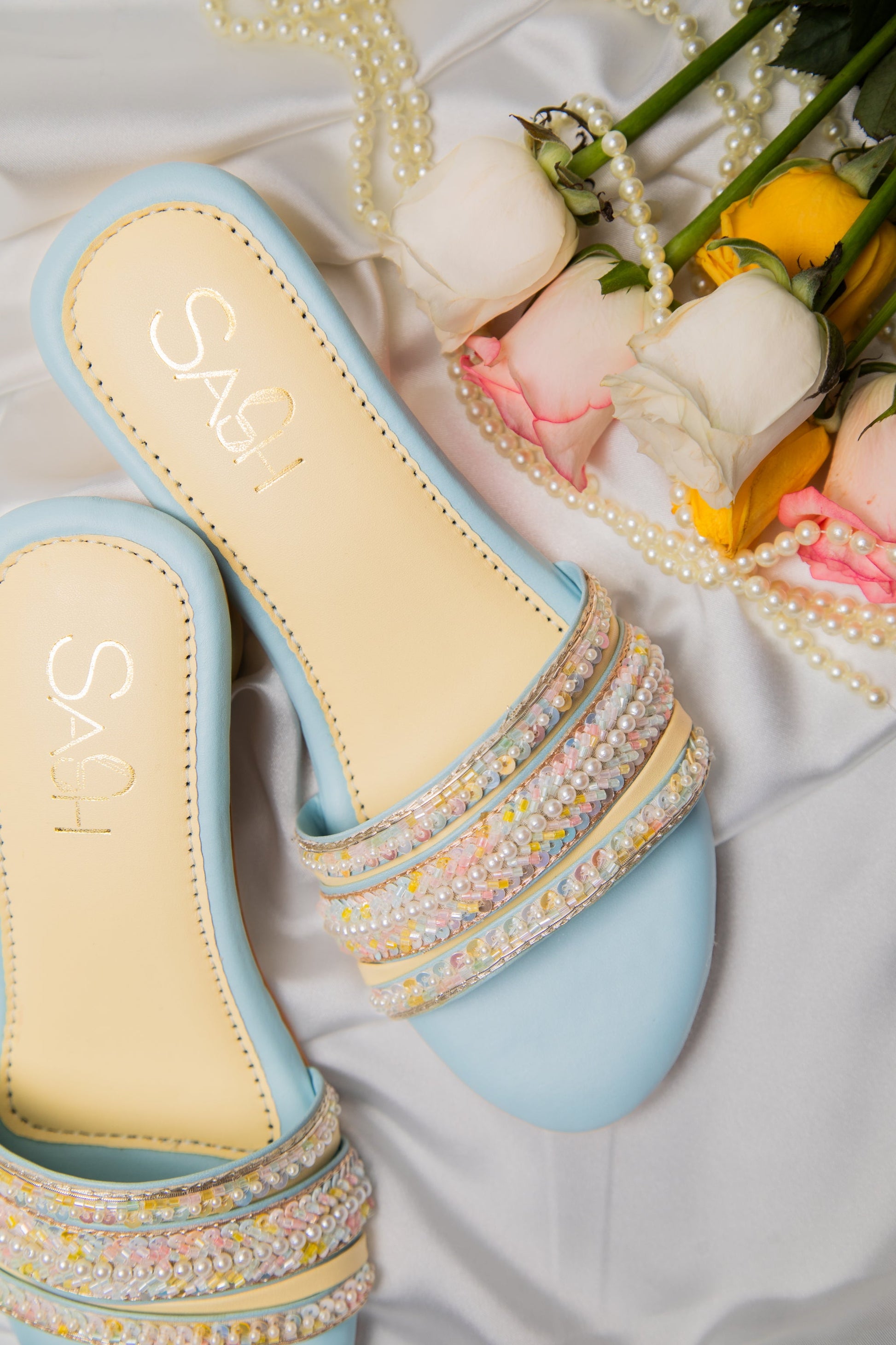 Powder Blue round 2 inch heels with slide straps of intrictae pastel pink, yellow and blue handwork with pearls
