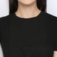 A smiling person, shown from shoulders to chin, wears the Black Twisted Crop Top.