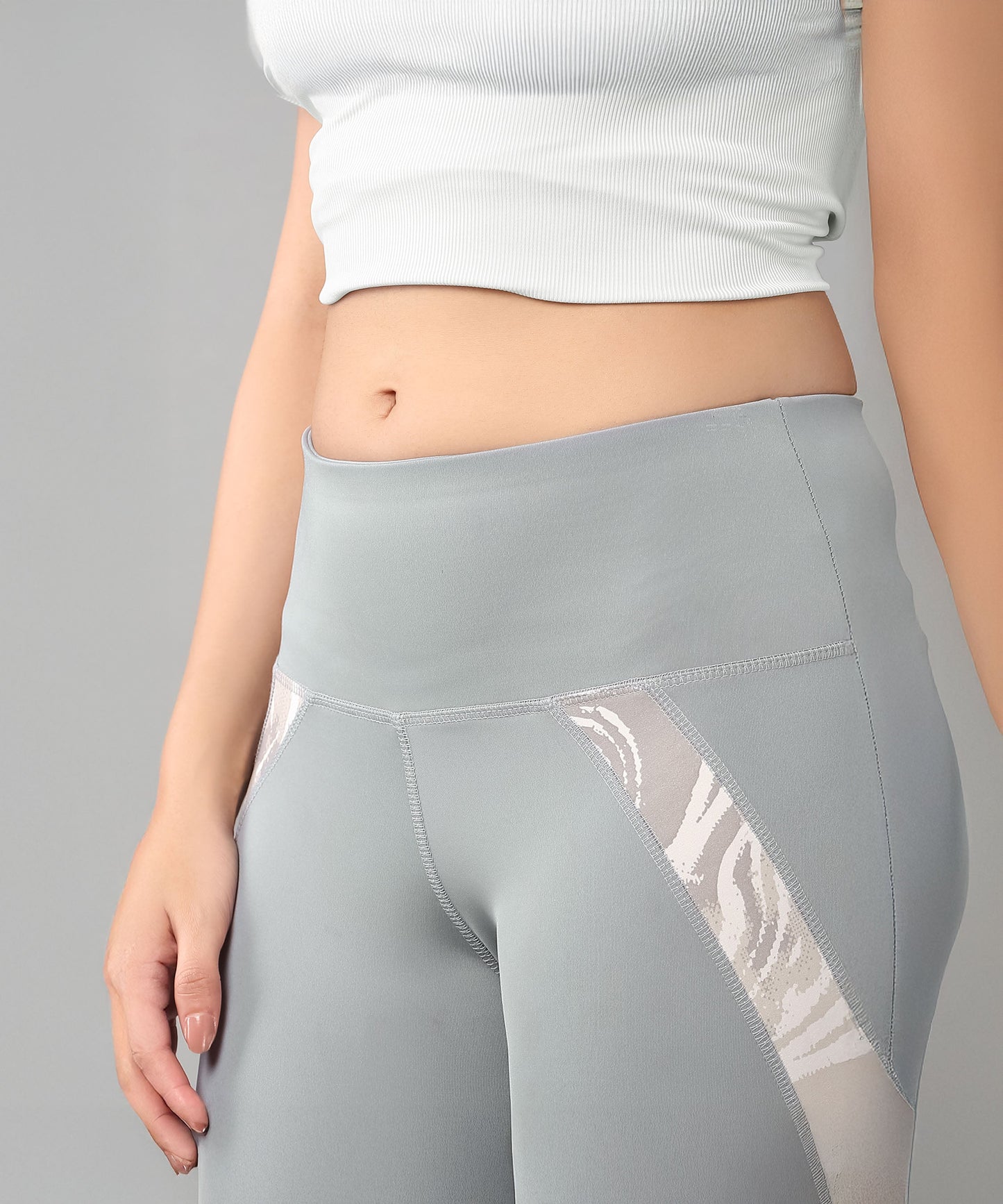 Woman in a Grey Top with Patched Legging, featuring moisture-wicking fabric to keep you cool while showing off your midriff.
