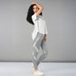 Woman wearing the Grey Top with Patched Legging, made from super soft fabric, poses confidently against a plain grey background.