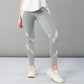 Model wears the Grey Top with Patched Legging, featuring light gray leggings with shiny silver stripes, paired with a white top and white sneakers against a plain background.