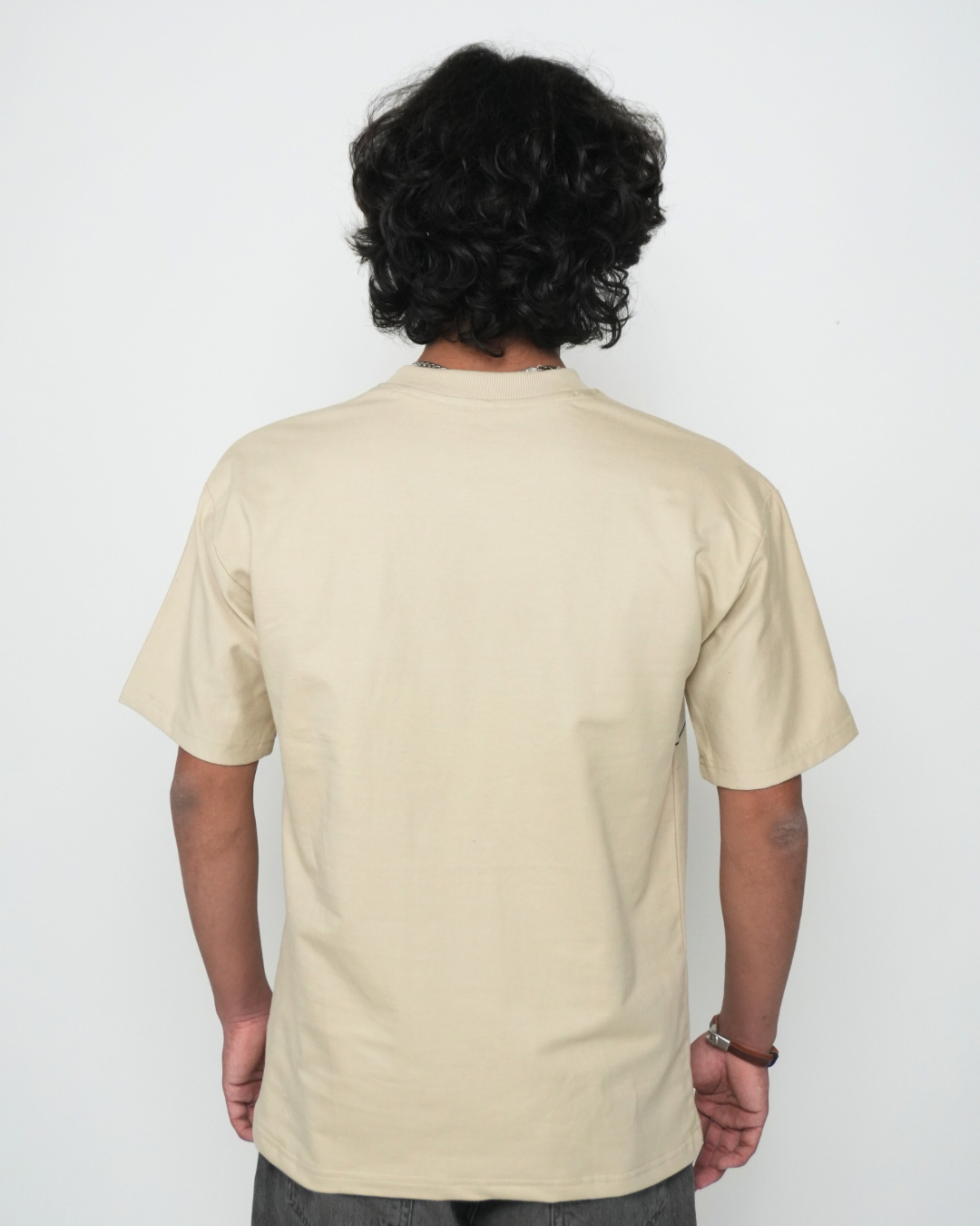 Stylera plain beige tee back view on male model showcasing trendy neutral color t-shirt