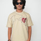 Stylera beige T shirt with abstract hand line art and red heart worn by model in sunglasses trendy neutral color t-shirt