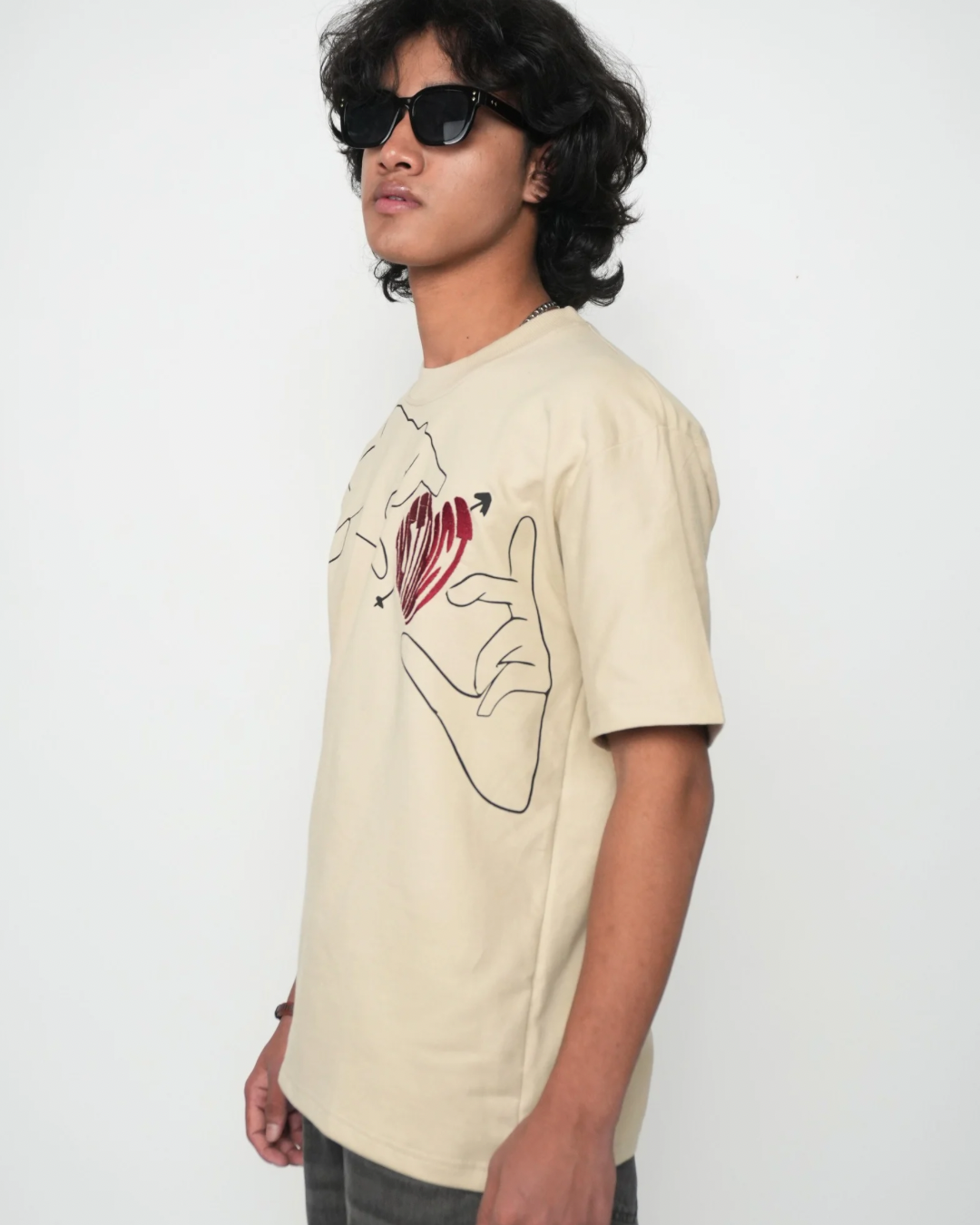 Stylera beige graphic tee with red heart line art worn by male model trendy neutral color t-shirt