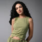 Woman with long curly black hair wears the Olive Corset Crop - Top with Parachute Pants, standing against a gray background.