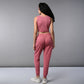 Woman with long dark hair wearing a Pink Corset Crop-Top with Joggers co-ord set, featuring a sleeveless top and joggers, facing away in white sneakers.