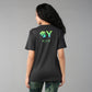 A woman with long curly hair, seen from behind, wears the Positive Body Image T Shirt—a black basic tee with green text and half sleeves—embracing positive body image.