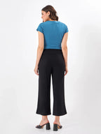 Female model wearing black pants from Stylera, showcasing backside