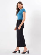 Female model wearing cropped length black pants from Stylera