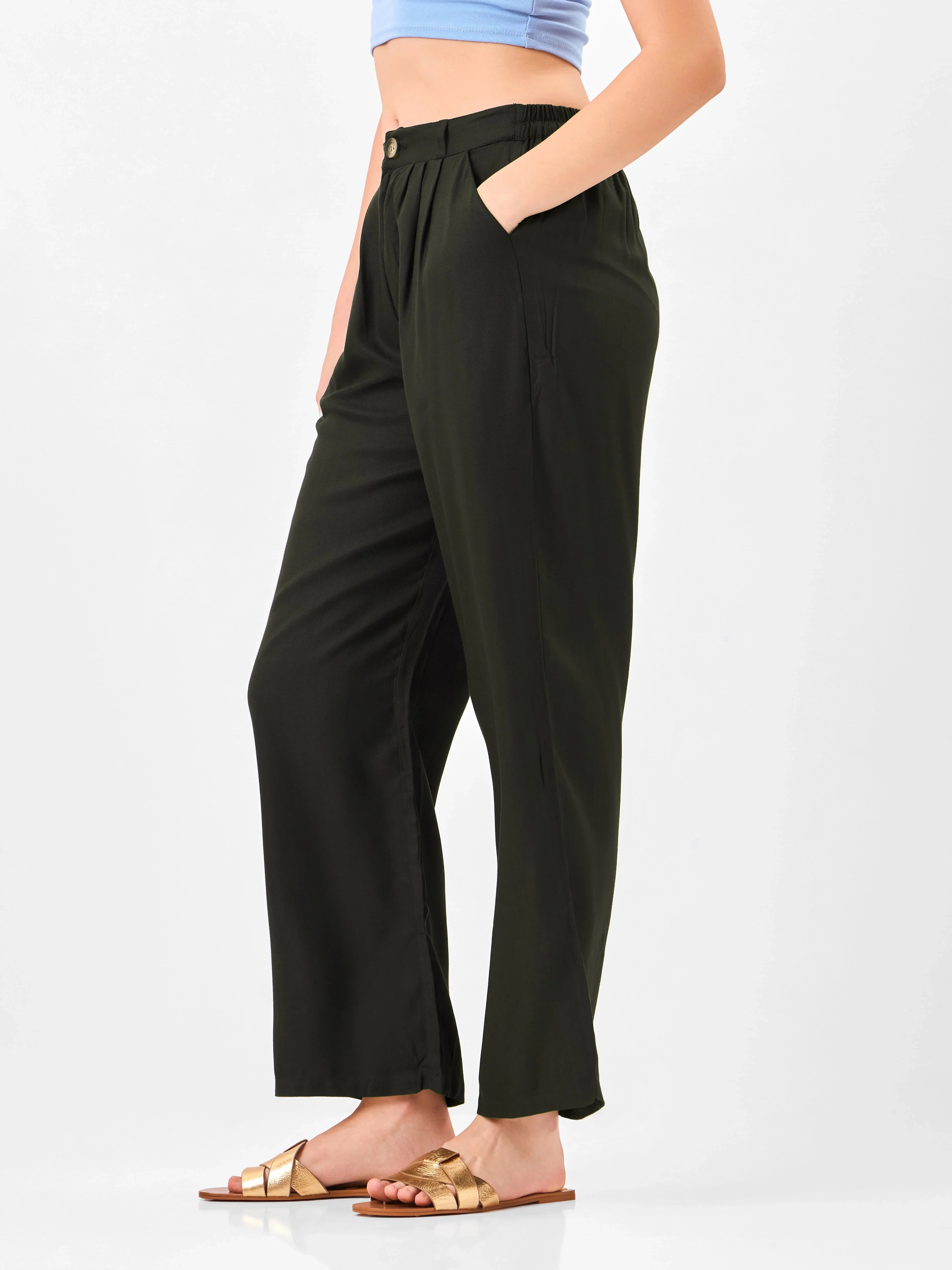 Female model wearing black relaxed fit trouser with button clouser from Stylera