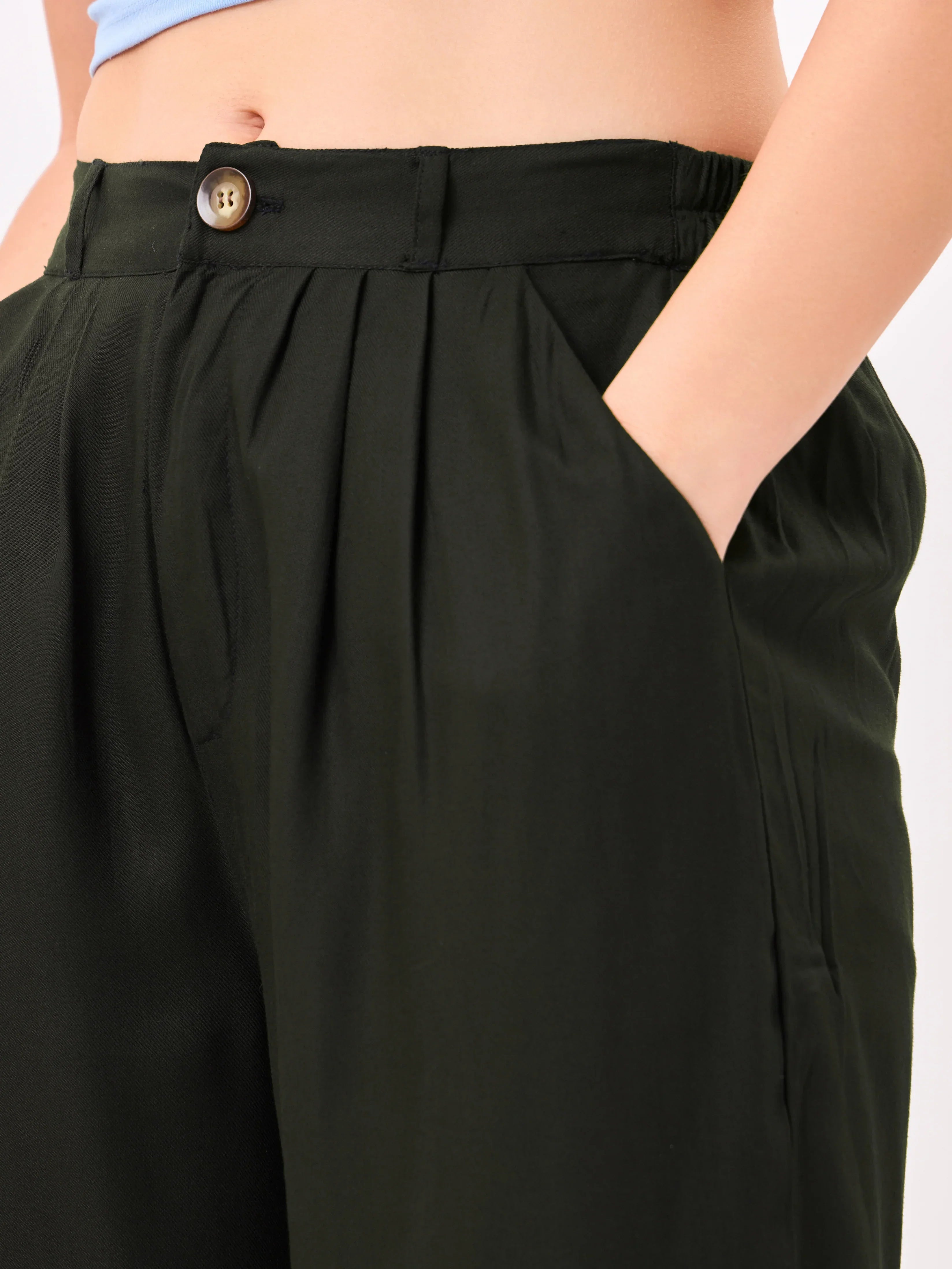 Female model wearing black relaxed fit trouser with slip pockets from Stylera