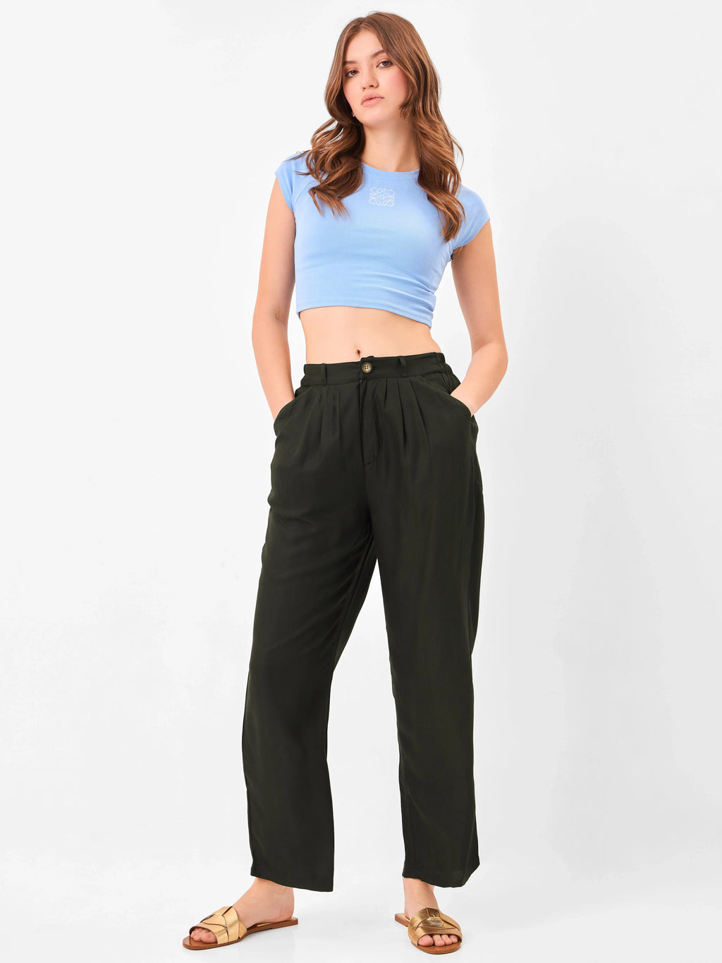 Female model wearing black relaxed fit trouser from Stylera, styling with blue top