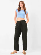 Female model wearing black relaxed fit trouser from Stylera, styling with blue top