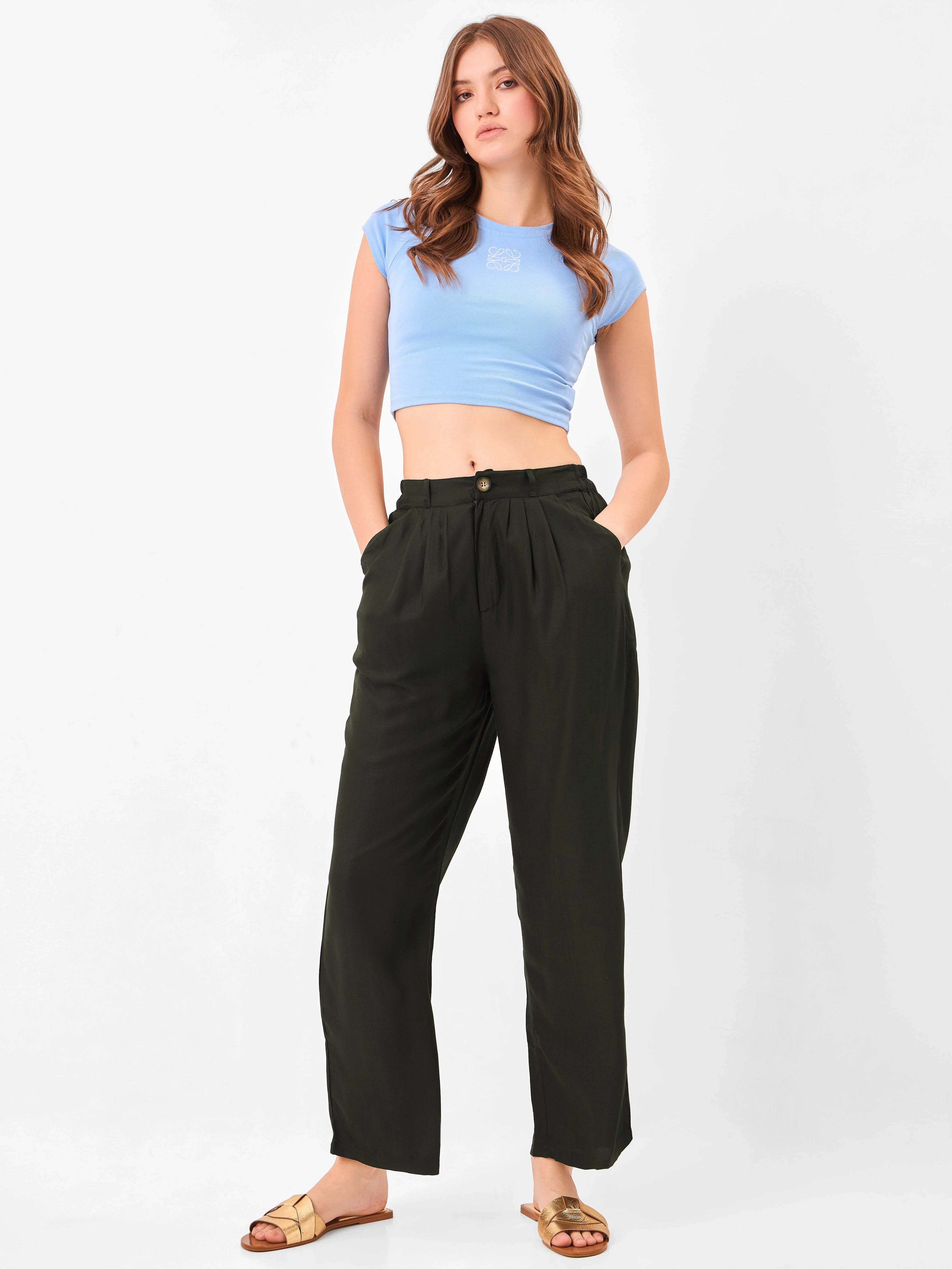 Female model wearing black relaxed fit trouser from Stylera, styling with blue top