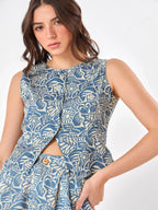 Female model wearing a blue patterned co-ord set includes button down crop top & shorts from Stylera