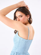 Female model wearing a light blue dress from Stylera