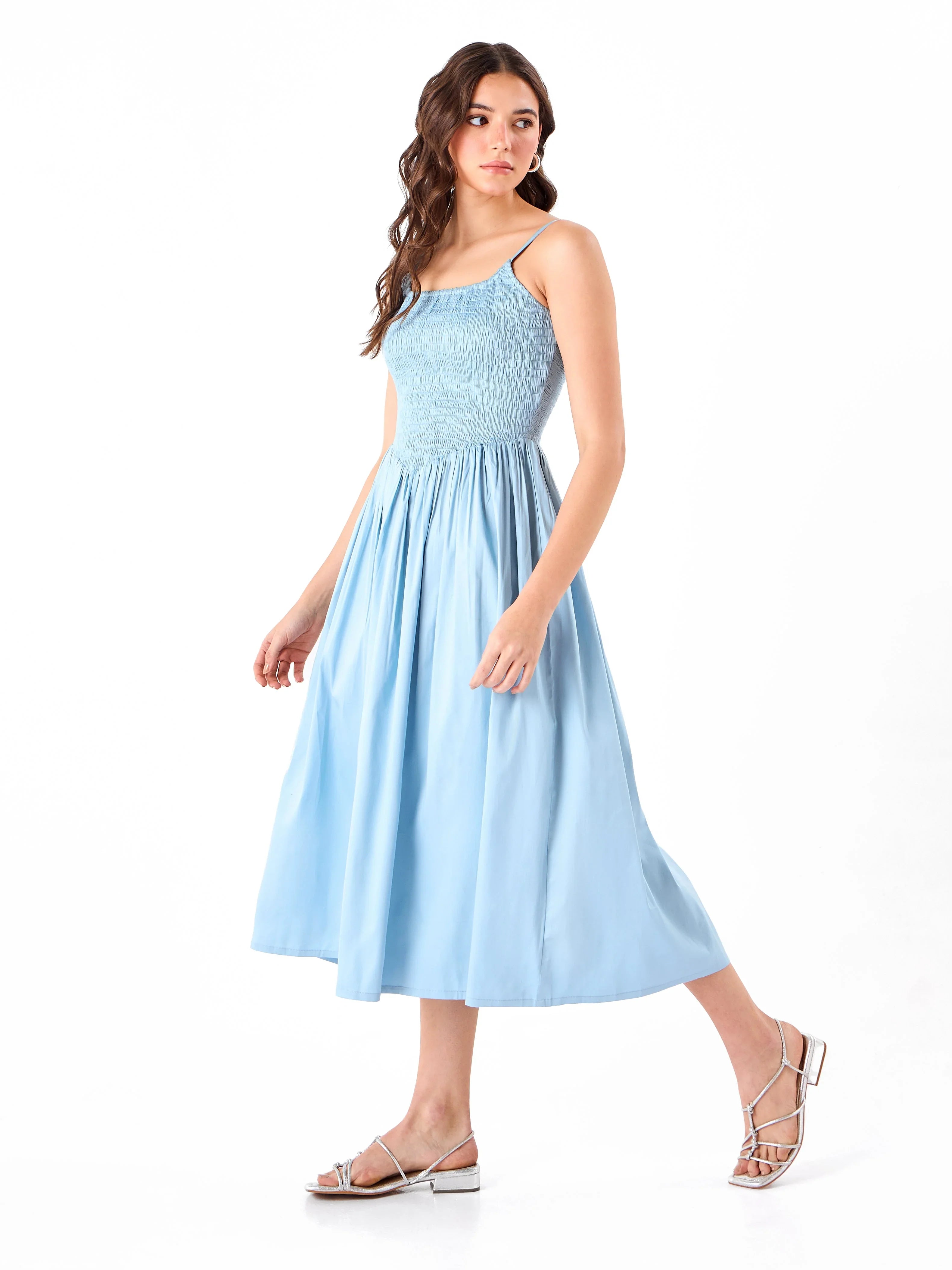 Female model wearing a spaghetti light blue dress from Stylera